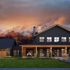 black barndominium with 3 car garage, wraparound porch, and mountains in the background