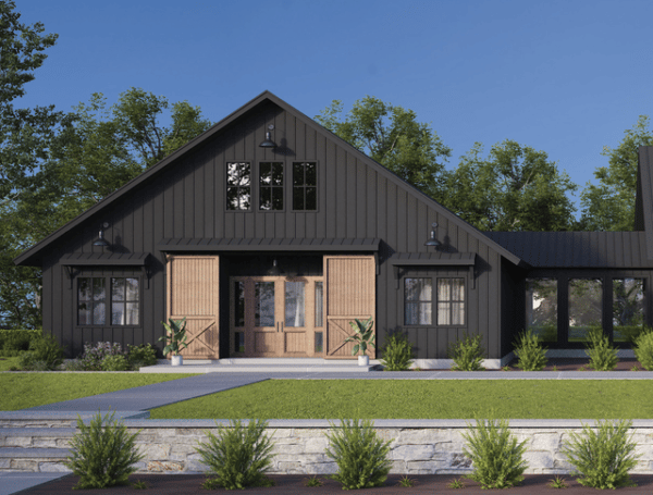 black barndominium with large barn doors leading into the entryway